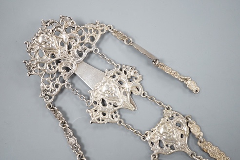 An Edwardian silver chatelaine, pierced and decorated with masks and scrolls, Nathan & Hayes, Chester, 1903, 21.6cm, 78 grams.